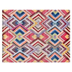 a colorful rug with an abstract design on the front and back side, in multicolors