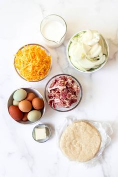 the ingredients to make this recipe include eggs, cheese, and meat in small bowls