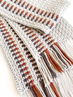 a close up of a scarf on a white surface