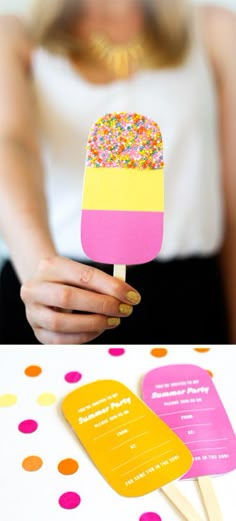 a woman holding a popsicle with sprinkles on it and the words flowers above it