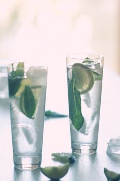 two glasses filled with water and lime slices