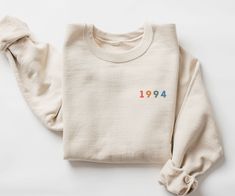 This 1994 sweatshirt is the perfect 30th birthday gift that will be loved for years to come!  Its colorful style is super cute and will bring so many compliments.  Celebrate your friends as they cross over into a new decade!  This unisex, heavy blend crewneck sweatshirt is pure comfort and will quickly become your go-to.           COLOR: This Gildan 18000 sweatshirt comes in several colors, look at the drop down for options.   SIZING: These sweatshirts are UNISEX in size.  Please check the size Christian Clothes, Clothes Photography, Christian Crewneck, Embroidery Crewneck, New Aunt, Embroidery Wedding, Etsy Shop Ideas, Cricut Project Ideas, Faith Clothing