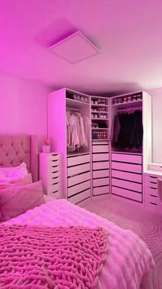 a bedroom with pink lighting and lots of closet space in the corner, including a bed