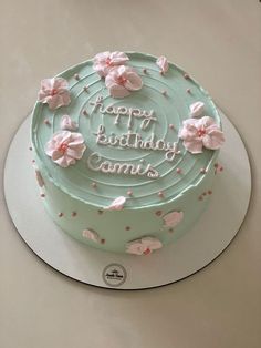 a birthday cake with pink flowers on it