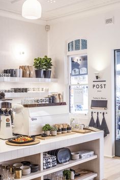 the inside of a coffee shop with lots of pots and pans on the counter