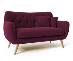 a purple couch sitting on top of a white floor next to a wooden leg chair