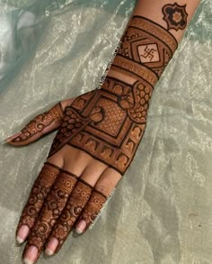 a woman's hand is decorated with hennap and intricate designs on it