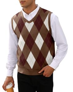 a man wearing a sweater vest and holding a drink