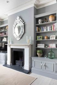 a living room filled with furniture and a fire place in front of a book shelf