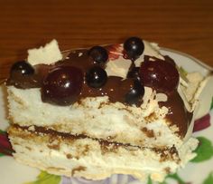 a piece of cake with chocolate and cherries on it