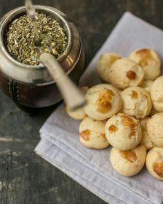 small pastries on a napkin next to a tea pot