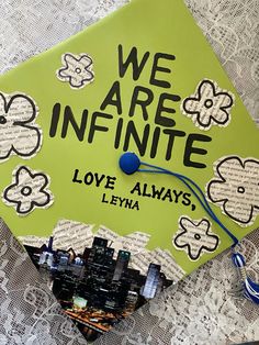 a green graduation cap with the words we are infinite love always written in black on it