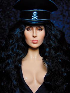 a close up of a doll wearing a police hat with long black hair and blue eyes