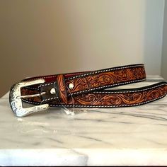 Dark Brown, Hand Tooled With Hide Inlay Leather Belt From Teskeys. Size 28” Longest Hole Measures At 29.50” And Shortest Hole Measures At 25.75”. See The Above Pictures Tooled Leather Womens Belt, Tooled Leather Belts Cheetah, Hand Tooled Leather Necklace, Tooled Leather Belts Cactus, Tooled Leather Belts Jacket, Womens Tooled Western Belts, Custom Hand Tooled Leather Belts, Cowgirl Belts, Bling Belts