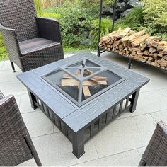 a fire pit sitting on top of a patio surrounded by wicker chairs and tables