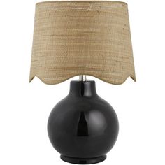 a black table lamp with a beige shade on the top and bottom part of it