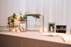 a table topped with pictures and candles