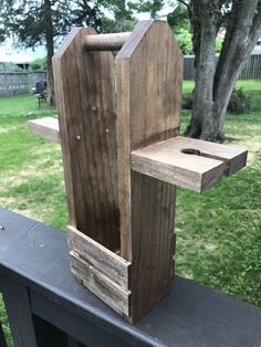 a wooden object sitting on top of a metal rail