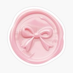 a pink wax stamp with a bow on it