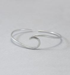 Wave cuff bangle, sterling silver, beach jewellery, ocean, beach bracelet, minimalist, adjustable, gift for her, one size Sterling silver solid cuff hand formed to a wave shape from 12 gauge (2 mm) wire. Comfortable to wear all day or sleep with and sturdy. This bangle is slightly adjustable and thus one size. It will fit most wrists (14 -18 cm / 5.5 - 7 inches wrist). But you can always ask for a different size. The bracelet above is not the exact one you will receive. Each one is handmade to o Minimalist Sterling Silver Jewelry For Beach, Simple Adjustable Sterling Silver Bracelets, Simple Adjustable Sterling Silver Bracelet, Adjustable Simple Sterling Silver Bracelet, Adjustable Ocean-inspired Jewelry For Everyday, Everyday Adjustable Ocean-inspired Jewelry, Adjustable Ocean-inspired Everyday Jewelry, Adjustable Silver Bracelets With Ocean-inspired Style, Adjustable Silver Bracelet With Ocean-inspired Style