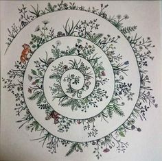 a drawing of a circular design with flowers and leaves on the center, in white paper