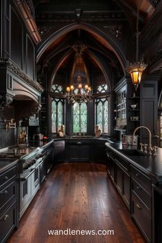 an ornate kitchen with dark wood floors and black cabinetry is pictured in this image