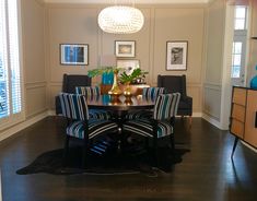 a dinning room table with blue chairs around it