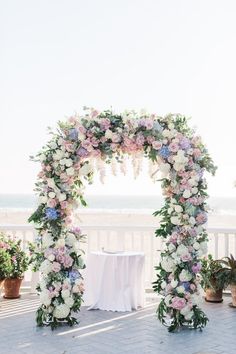 an outdoor wedding ceremony setup with flowers and greenery