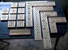 several pieces of carved wood sitting on top of a table