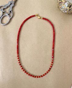 Handmade Red Coral Gemstone with Gold Beads Necklace, a captivating piece that exudes a combination of vibrant energy and timeless sophistication.  This necklace showcases the natural beauty of red coral gemstones, carefully handcrafted alongside shimmering gold beads. The warm glow of the gold perfectly complements the fiery intensity of the coral, creating a harmonious balance that catches the eye. Its adjustable length allows for a customized fit, while a secure clasp ensures ease of wear and peace of mind. Whether you're attending a special occasion or looking to add a bold statement to your everyday ensemble, the Handmade Red Coral Gemstone with Gold Beads Necklace is the ideal choice. Its unique combination of fiery red coral and gleaming gold beads makes it a standout piece that emb Elegant Red Beaded Necklace With Colorful Beads, Elegant Red Beaded Necklace, Red Rondelle Gemstone Beaded Bracelets, Elegant Red Rondelle Beads, Red Beaded Bracelets With Gemstone Beads, Red Gemstone Beaded Bracelets, Red Crystal Necklaces With Gemstone Beads, Red Gemstone Beaded Spiritual Bracelets, Red Crystal Necklace With Gemstone Beads