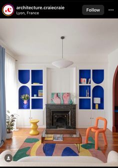 a living room with blue and white decor on the walls, furniture and rugs