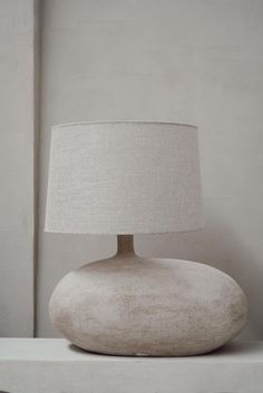 a white lamp sitting on top of a table