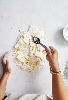 a person mixing ingredients in a bowl with a spoon