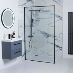 a bathroom with marble walls and flooring next to a sink, mirror and radiator