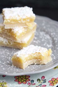 three pieces of cake on a plate with powdered sugar and sprinkles