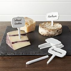 the cheese board has four different types of cheese on it, and two are labeled with names