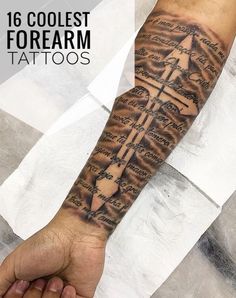 a man with a cross tattoo on his arm and wrist is holding the hand of another person