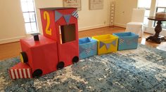 a train made out of cardboard sitting on top of a rug