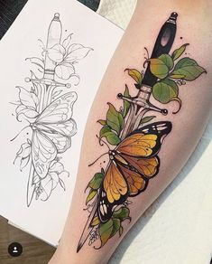 a tattoo with butterflies on it and a knife in the middle, sitting next to a piece of paper