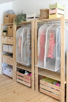 an organized closet with clear plastic bags on the shelves and wooden crates under it in front of a white wall