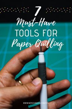 a hand holding a pen with the words 7 must have tools for paper quilting