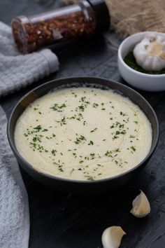 garlic parmesan sauce in a black bowl