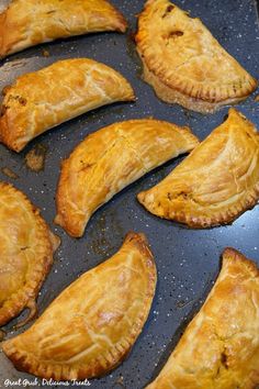 baked pastries on a baking sheet ready to be cooked in the oven for consumption