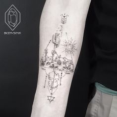 a person with a tattoo on their arm that has an image of a desert and cactus