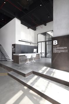 the interior of an office building with stairs and desks