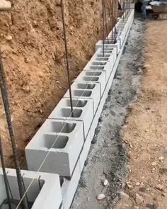 concrete blocks are lined up on the side of a road