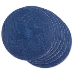 four blue placemats with an intricate design on the top and bottom, set against a white background