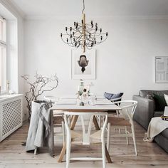 a dining room with a chandelier hanging from the ceiling