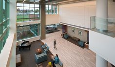 the interior of an office building with high ceilings and large windows on either side of the lobby