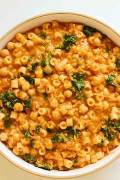 a bowl filled with macaroni and cheese on top of a white countertop